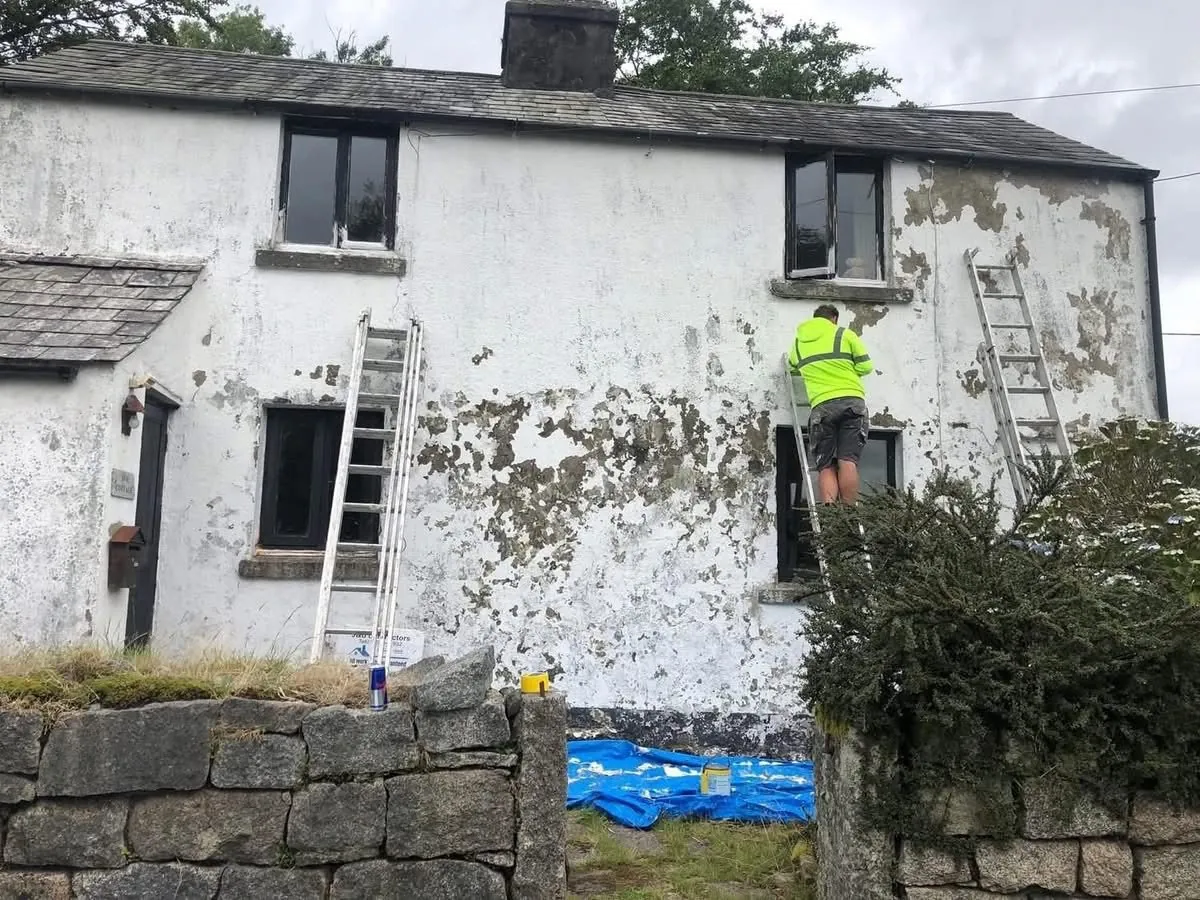 Cottage with blown, flaking render before repair in Penzance